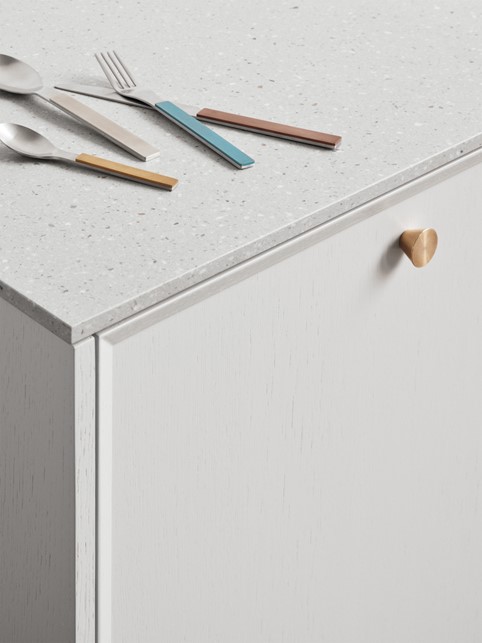 Kitchen cabinet with brass handle and Corian countertop